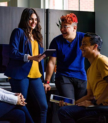 A group of people sitting around each other.