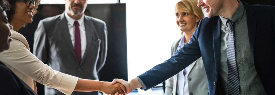 A group of people shaking hands in an office.